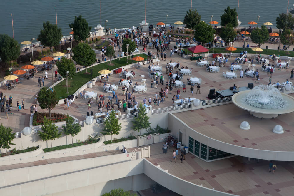 Aerial view of the rooftop terrace looking over the lake with a large event going on