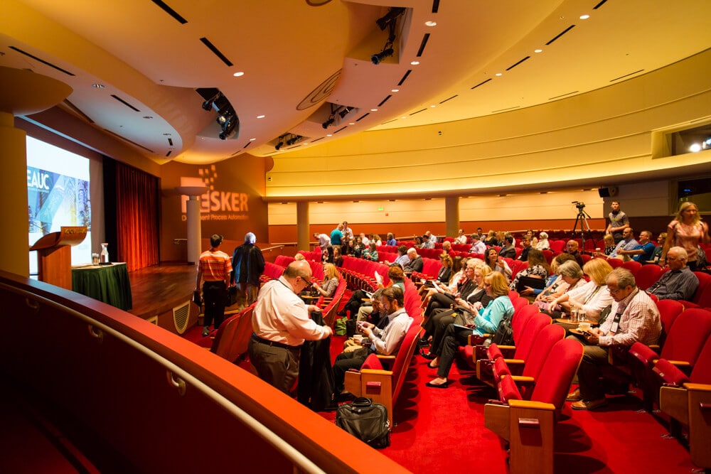 Lecture Hall before a presentation with people sitting in the audience