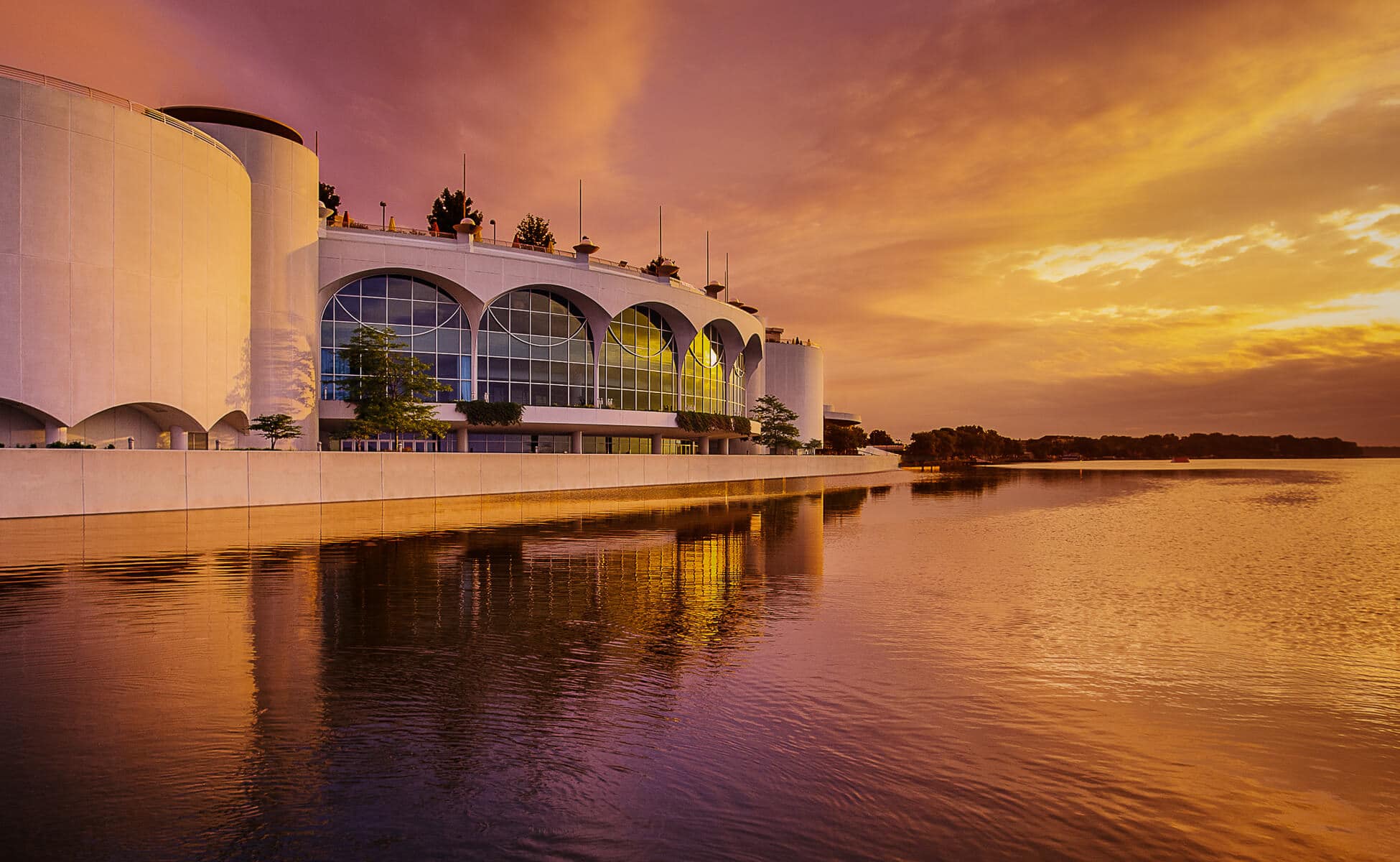 An artistic view of Monona Terrace from the lake at sunset