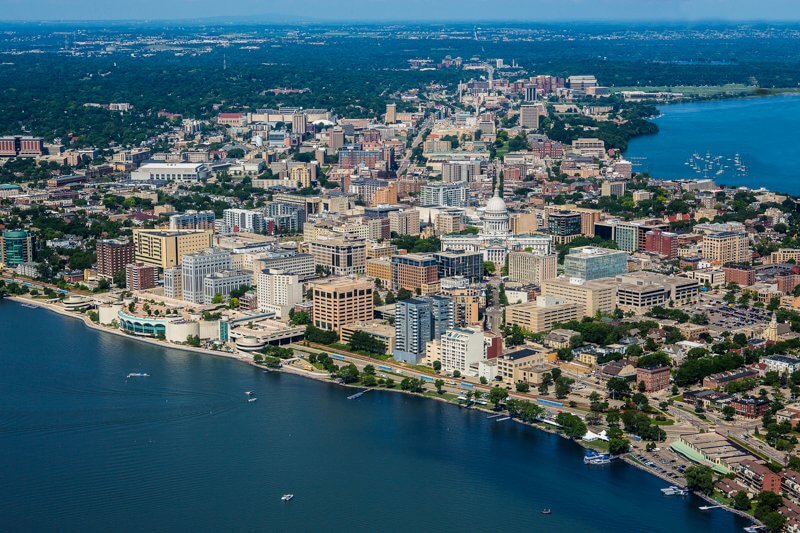 Aerial view of Madison with Lake Monona, city buildings stacked together and Monona Terrace standing out on the lakeshore