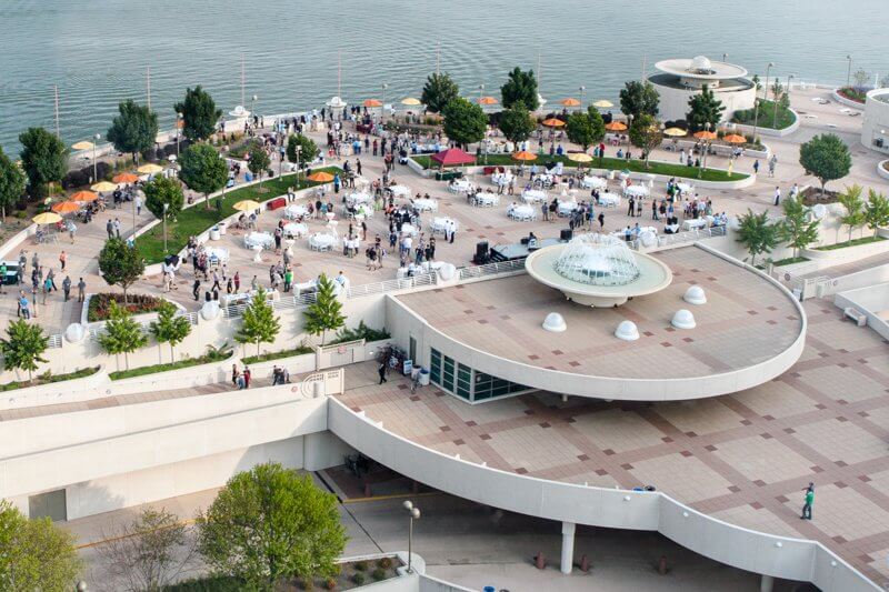 Aerial view of the rooftop terrace looking over the lake with a large event going on
