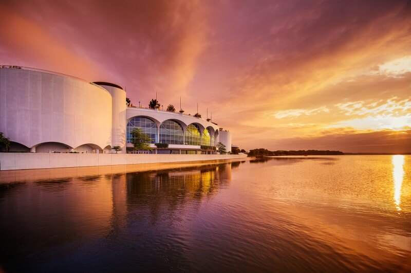 An artistic view of Monona Terrace from the lake at sunset