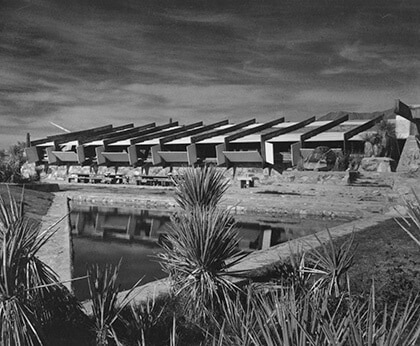 A black-and-white photograph by Guerrero of a view over the reflecting pool of Taliesin West designed by Wright.