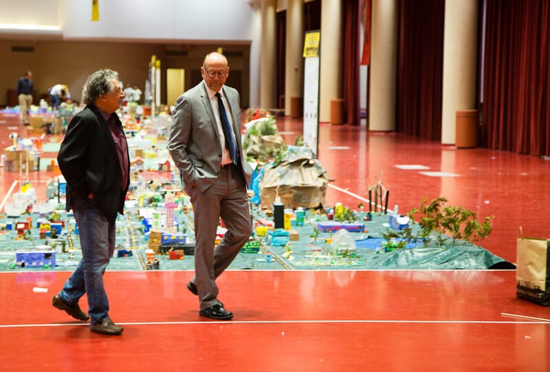 two man walking next to a LEGO table