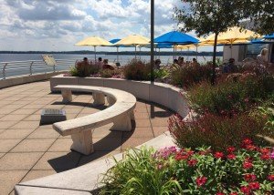 A stone bench next to Lake Vista Cafe with a view of the lake