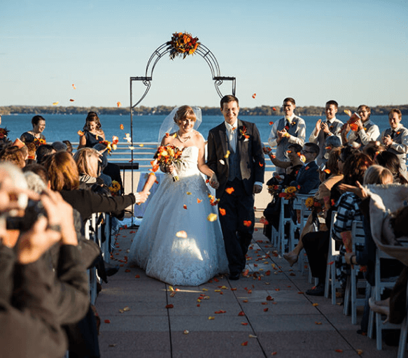 Couple holding hands after getting married in a terrace