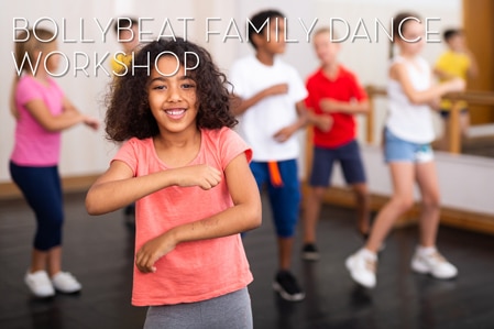 Portrait of happy preteen girl practicing dynamic synchronous choreography with her family in modern dance studio.