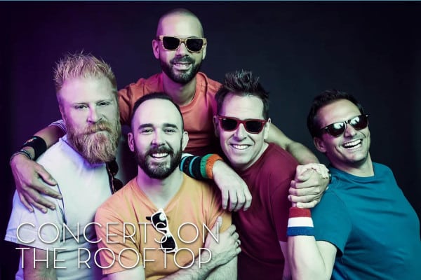 Five smiling men pose closely together against a dark background, wearing colorful shirts and sunglasses. The text "Concerts on the Rooftop" is at the bottom.